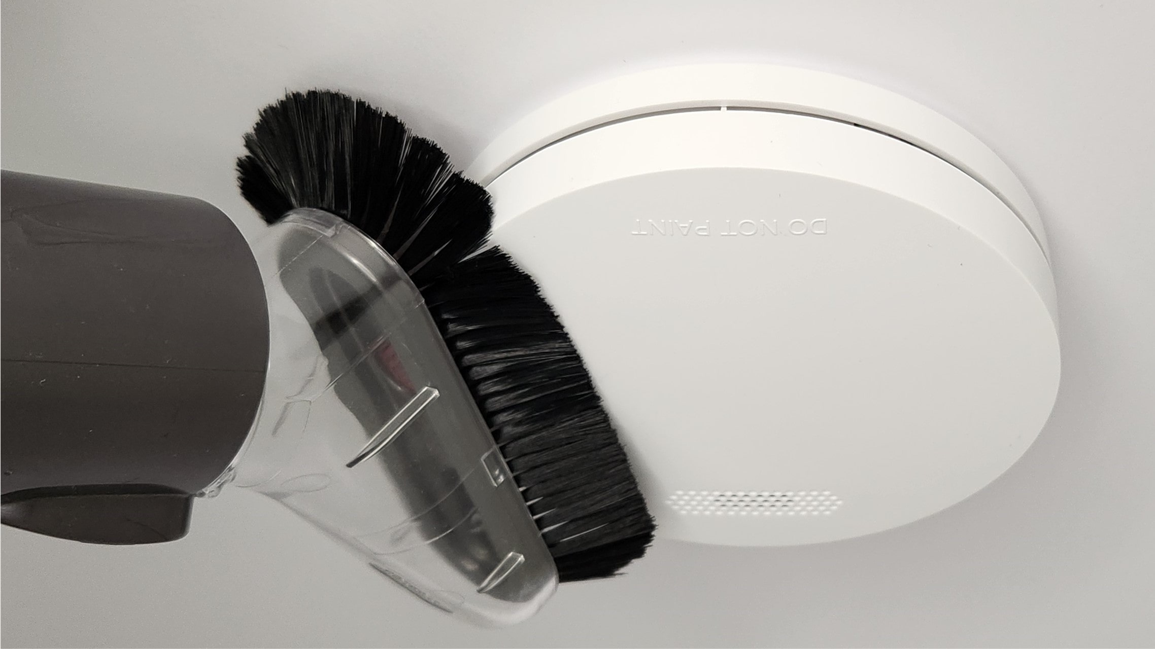 ZEN photoelectric smoke alarm cleaning with soft brush attachment from a vacuum