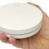 ZEN photoelectric smoke alarm being held by a hand (close-up)