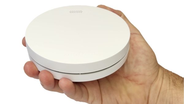 ZEN photoelectric smoke alarm being held by a hand (close-up)