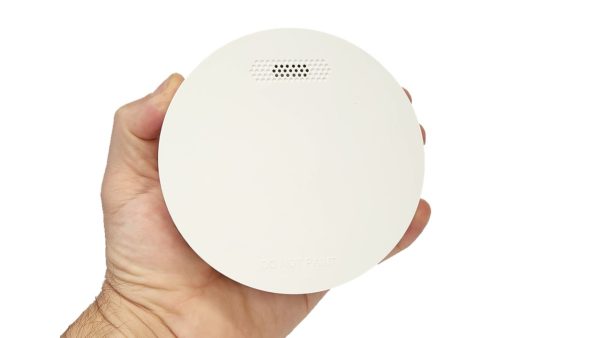ZEN photoelectric smoke alarm being held by a hand (front view)