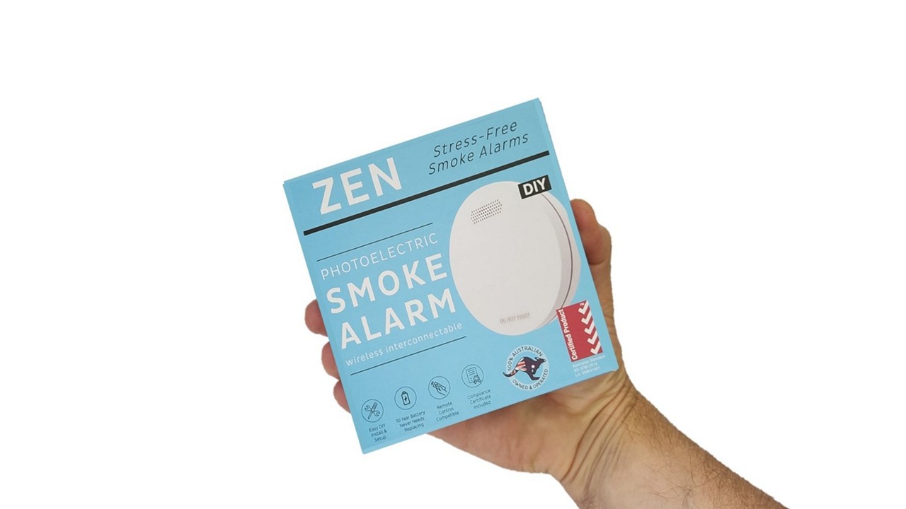 ZEN photoelectric smoke alarm 1-pack being held by a hand - close up image